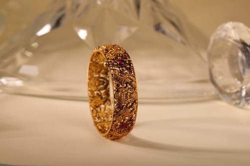Konikkara 22kt gold Nagas bangle with ruby stones and deity motifs