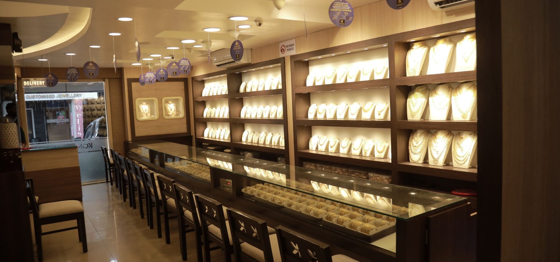 Inside the Konikkara Tower showroom — illuminated gold display counters in Thrissur